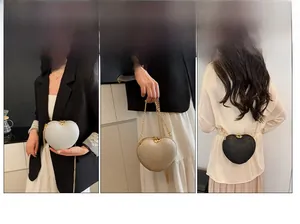 Detailed view of heart-shaped evening clutch bag in gold, silver, and black glitter finish