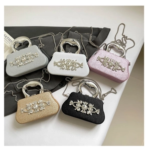 Detail of luxury rhinestone clutch bags in five colors with metal top handles and chains