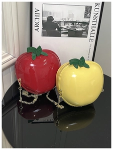 Gros plan sur les sacs pomme créatifs rouge et jaune avec bandoulières dorées