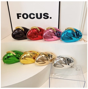 Mirror-finish metallic clutch bags in multiple colors displayed on tiered stands