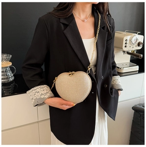 Fashionable heart-shaped crossbody bag with champagne glitter finish and metal chain strap