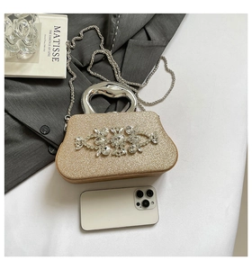 Detail of champagne gold evening bag with rhinestones and unique metal handle