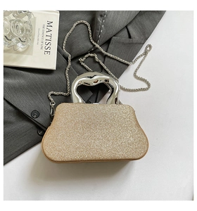 Macro shot of glitter evening bag with silver metal handle and detachable chain strap