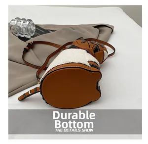 Detail showing the durable bottom of the cute animal tiger-shaped crossbody bucket bag