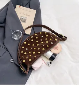 Detail view of brown suede half-moon bag interior showing spacious storage for daily items