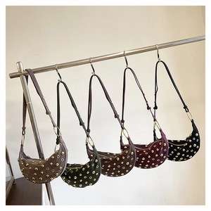 Detailed close-up of five colorful hobo bags with metallic studs and crescent shape