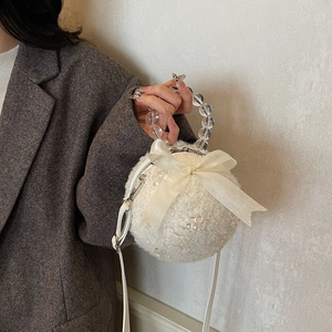 White plush ball-shaped shoulder bag with organza bow and clear beaded handle