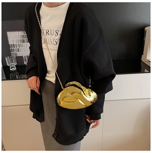 Close-up of gold mirror metallic rabbit shaped clutch bag with luxury chain strap