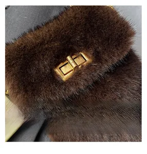 Macro shot of dark brown plush bag featuring premium faux fur and golden twist lock detail