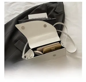 Detail view of the cream crossbody bag interior showing storage space for daily essentials
