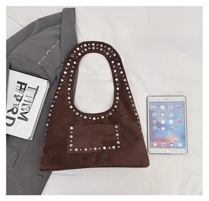 Size comparison showing brown suede hobo bag with silver studs and daily essentials