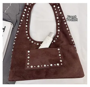 Detailed close-up of brown suede tote bag featuring a practical front slip pocket