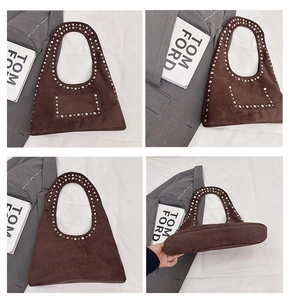 Detail view of dark brown suede tote bag featuring silver studs and vintage aesthetic