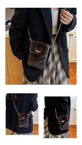 Detail of dark brown plush crossbody bag with gold chain and metal twist lock