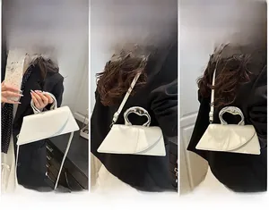 Three ways to wear the white trapezoid handbag with silver liquid metal handle detail
