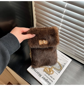 Close-up of brown plush mini square bag with golden chain and metallic flip lock