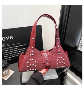 Detail of dark red leopard embossed faux leather bag with silver punk rivets