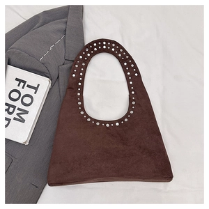 Detailed top view of dark brown suede tote bag with stylish silver metal rivet studs