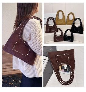 Macro detail of hobo bag with silver rivets and internal storage capacity for essentials