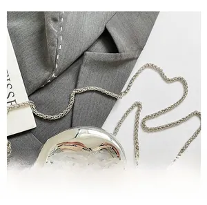 Close-up of sparkling evening bag with metallic silver handle and sleek chain strap
