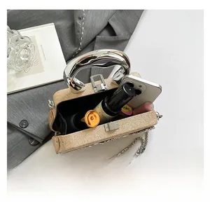 Internal capacity of the gold sequined evening bag with phone and perfume items