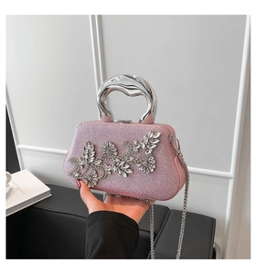 Detailed view of pink glitter evening bag with crystal floral motifs and silver handle