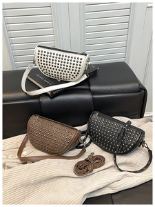 Detail of studded crossbody bags in white, brown and black with adjustable straps