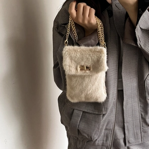 Faux fur beige crossbody bag with gold chain strap and metal turn-lock closure