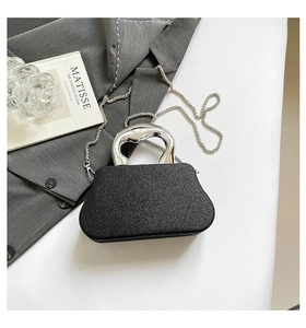Detail of glitter evening bag with liquid metal handle and silver chain strap