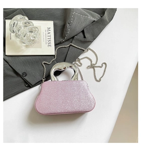 Pink glitter evening bag featuring a silver irregular metal handle and a long chain strap