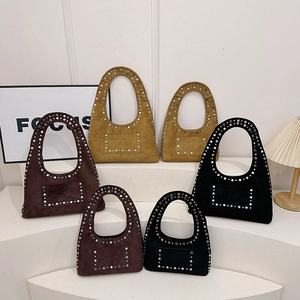 Minimalist rivet suede tote bag in three colors and two sizes shown on stepped display