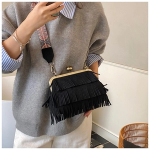 Détail du sac bandoulière en daim noir avec franges et bandoulière tissée ethnique