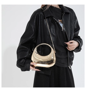 Polished gold mirror acrylic crescent bag with round hollow handle and chain on model