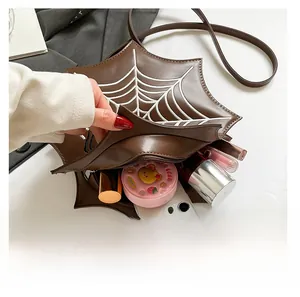 Interior view showing capacity for a smartphone and makeup in a spider web shaped bag