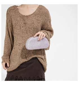 Model holding a purple rhinestone evening clutch bag with sparkling diamond surface
