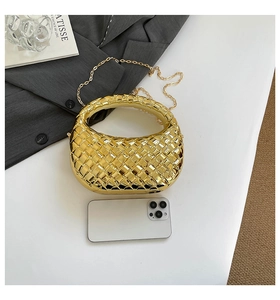 Detail of gold woven hobo clutch with chain strap and phone for size reference