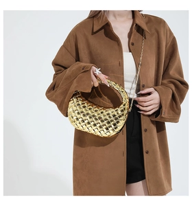 Detail of gold woven half-moon hobo bag with a metallic finish and crossbody chain