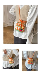 Detail of handmade crochet bucket bag with floral accents and contrast checkered pattern