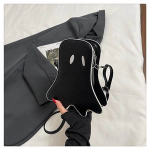 Detail of ghost-shaped crossbody bag with white piping and silver oval eye accents