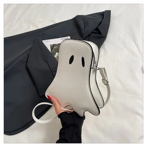 Detail of white ghost crossbody bag with black eye patches and adjustable PU shoulder strap