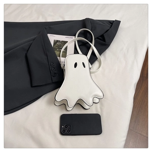 Close-up of ghost-shaped mini crossbody bag with smooth PU leather and black trim