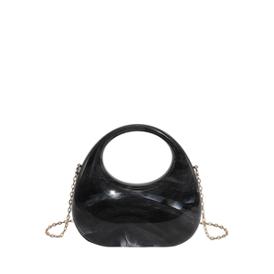 Detail of grey marble acrylic evening clutch with gold chain strap and round handle