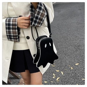 Close-up of ghost-shaped crossbody bag with white eye patches and wavy bottom edges