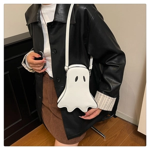 Close-up of ghost-shaped white leather crossbody bag with cute black dot eyes design