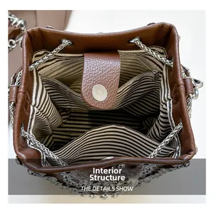 Top view of bucket bag showing striped lining, magnetic buckle, and interior pockets