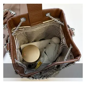 Top view of spacious bucket bag interior with striped lining and daily essentials