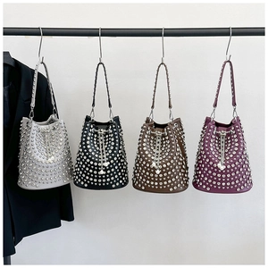 Detailed view of bucket bags with stud embellishments and pearl drawstring in four colors