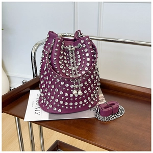 Detail of purple bucket bag featuring silver rivets and pearl drawstring accents