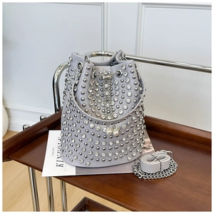 Close-up of grey bucket bag with silver rhinestones, pearls and chain drawstring details