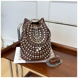 Detailed shot of brown pebble leather bucket bag with silver rhinestones and pearl drawstring